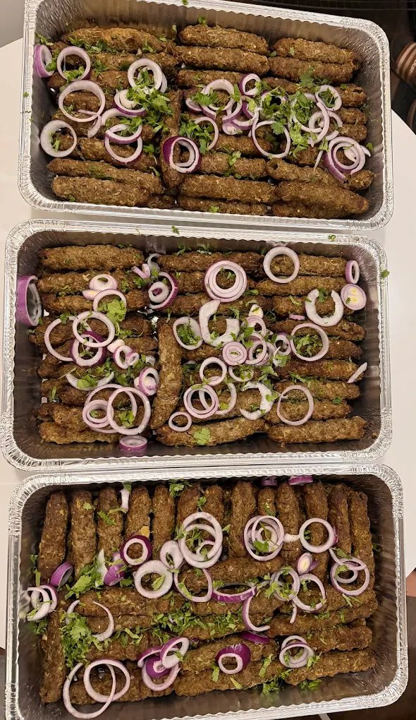 Seekh kebab trays with onion and cilantro